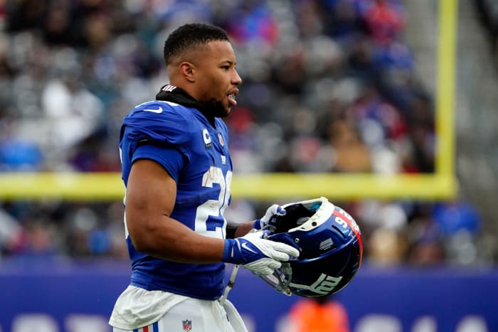 New York Giants running back Saquon Barkley (26) walks onto the field in the second half. The Giants lose to Washington, 22-7, at MetLife Stadium on Sunday, Jan. 9, 2022.